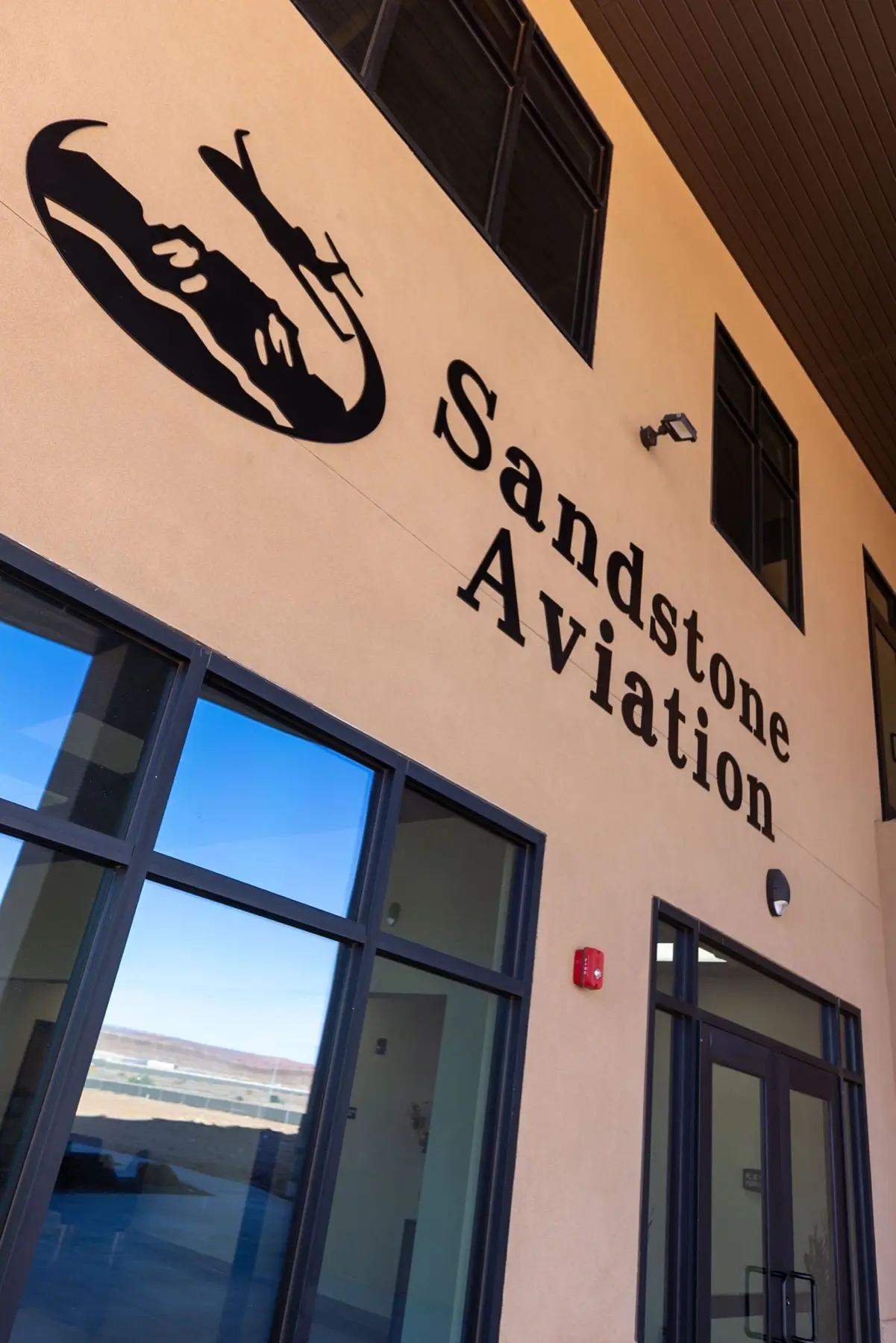 Sandstone Aviation logo and signage above the facility entrance.
