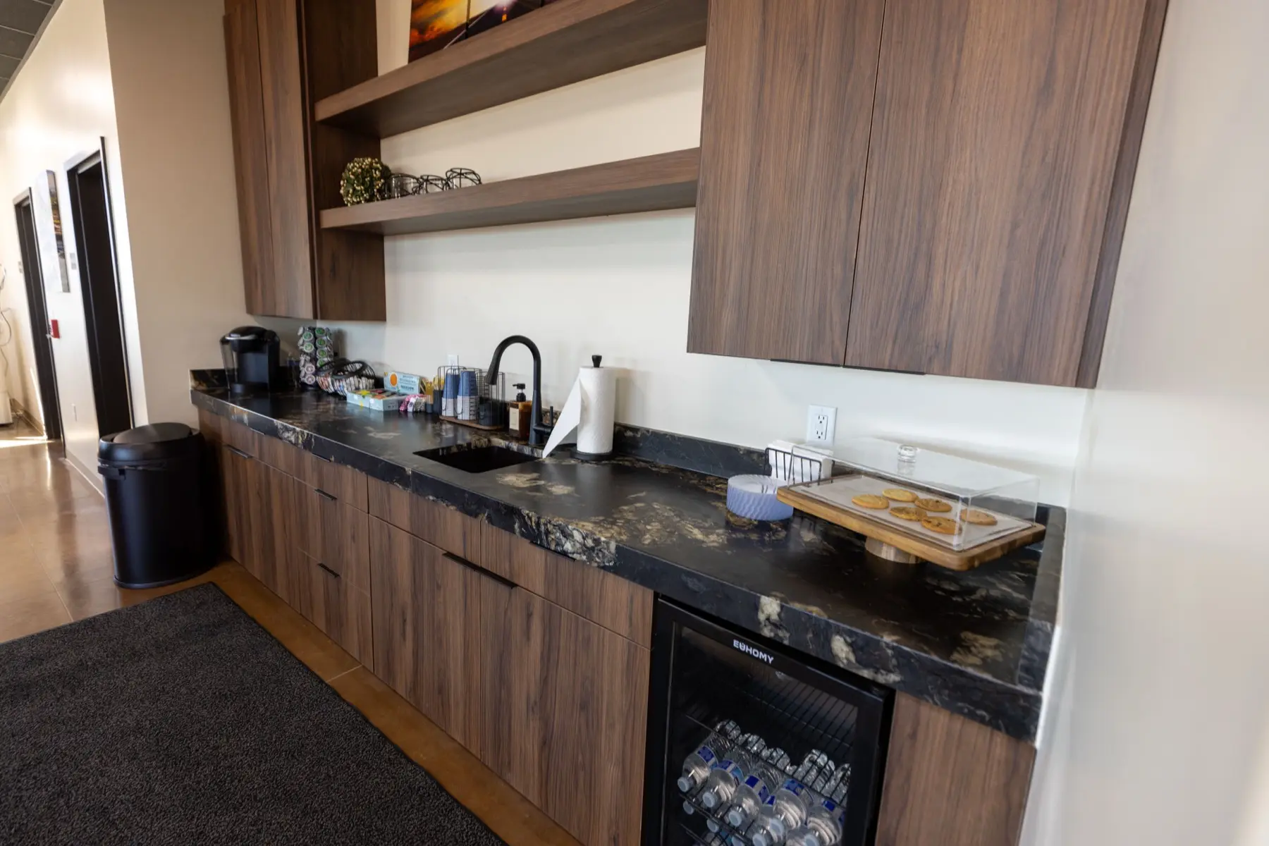 Refreshment area with coffee, snacks, and bottled water at Sandstone Aviation.