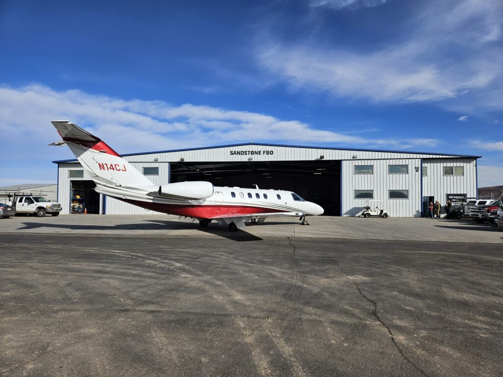 Aircraft parked outside Sandstone Aviation FBO hangar